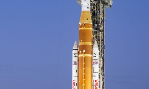 NASA's orange and white Space Launch System rocket on the launch pad.