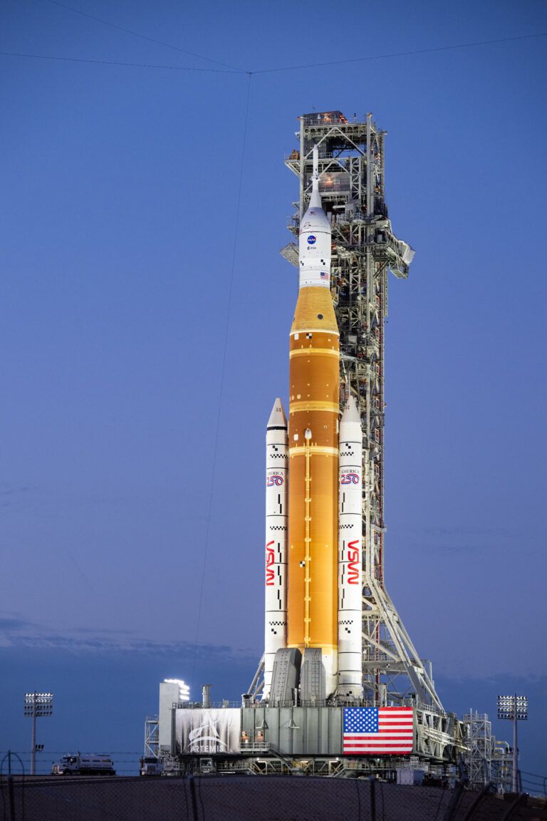 NASA's orange and white Space Launch System rocket on the launch pad.