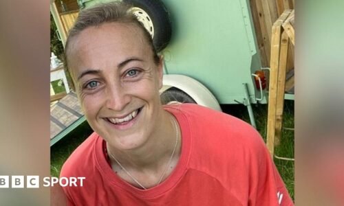 Amy Carr smiling at the camera and wearing a sports shirt