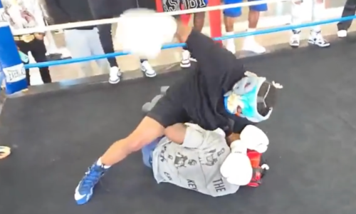 Deen The Great in black throws illegal ground and pound punches on Keyshawn Davis during a boxing spar