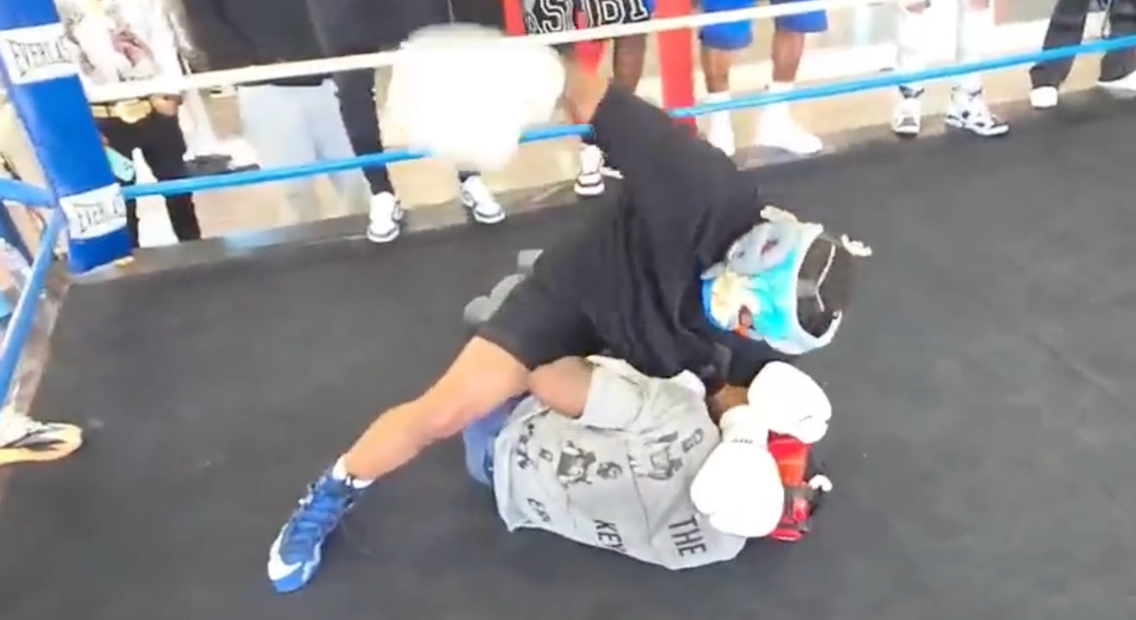 Deen The Great in black throws illegal ground and pound punches on Keyshawn Davis during a boxing spar