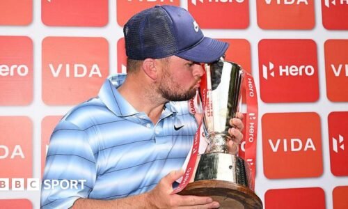 Alex Fitzpatrick kisses the Indian Open trophy