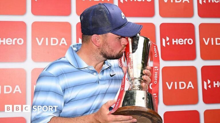 Alex Fitzpatrick kisses the Indian Open trophy