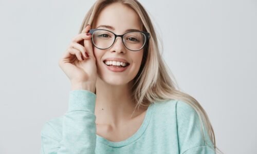 cheerful-female-student-stylish-eyewear-rejoices-successfully-passed-exams-glad-have-meeting-with-groupmates-delighted-beautiful-pleased-woman-has-attractive-look-poses-indoors