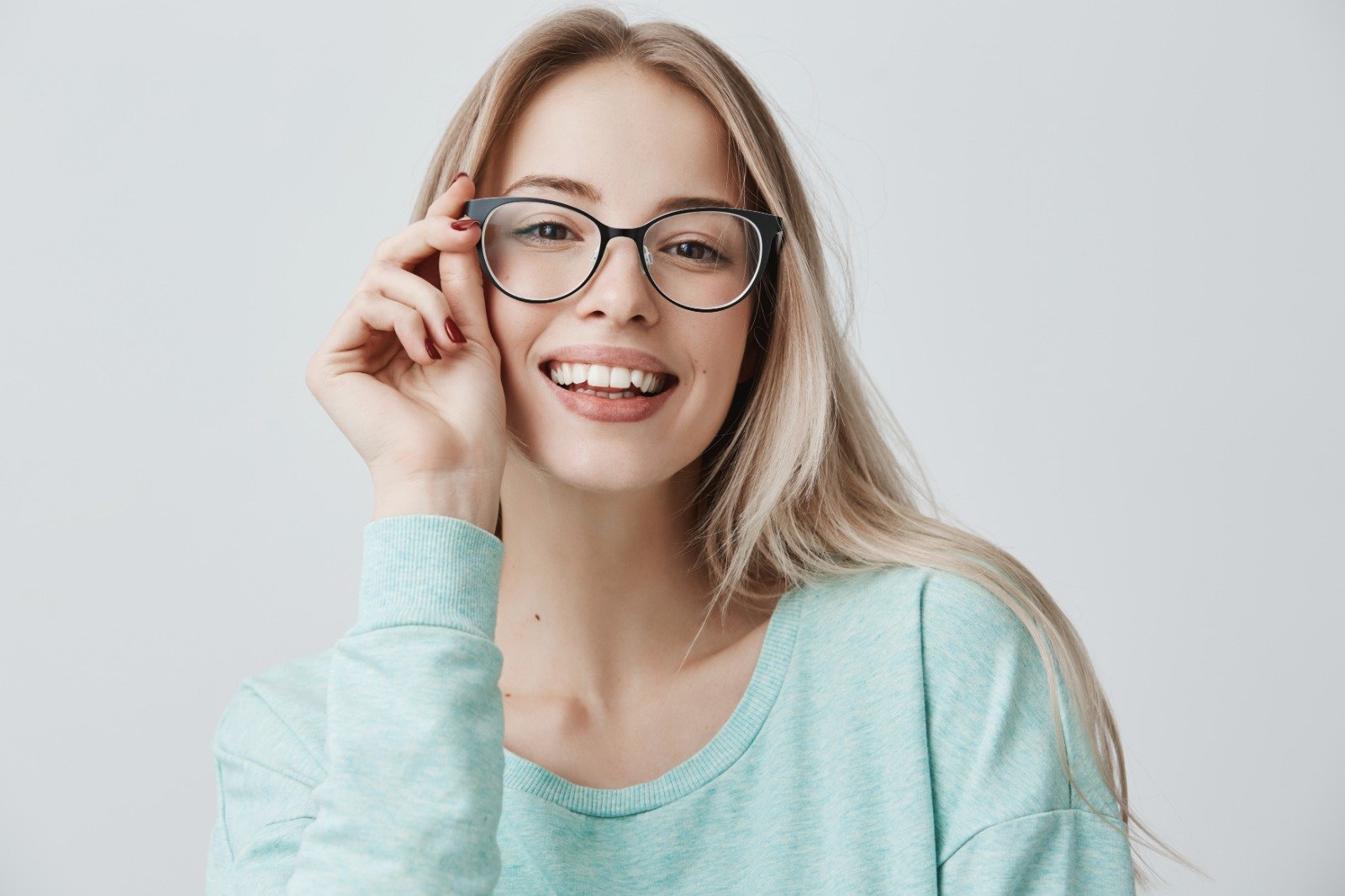 cheerful-female-student-stylish-eyewear-rejoices-successfully-passed-exams-glad-have-meeting-with-groupmates-delighted-beautiful-pleased-woman-has-attractive-look-poses-indoors