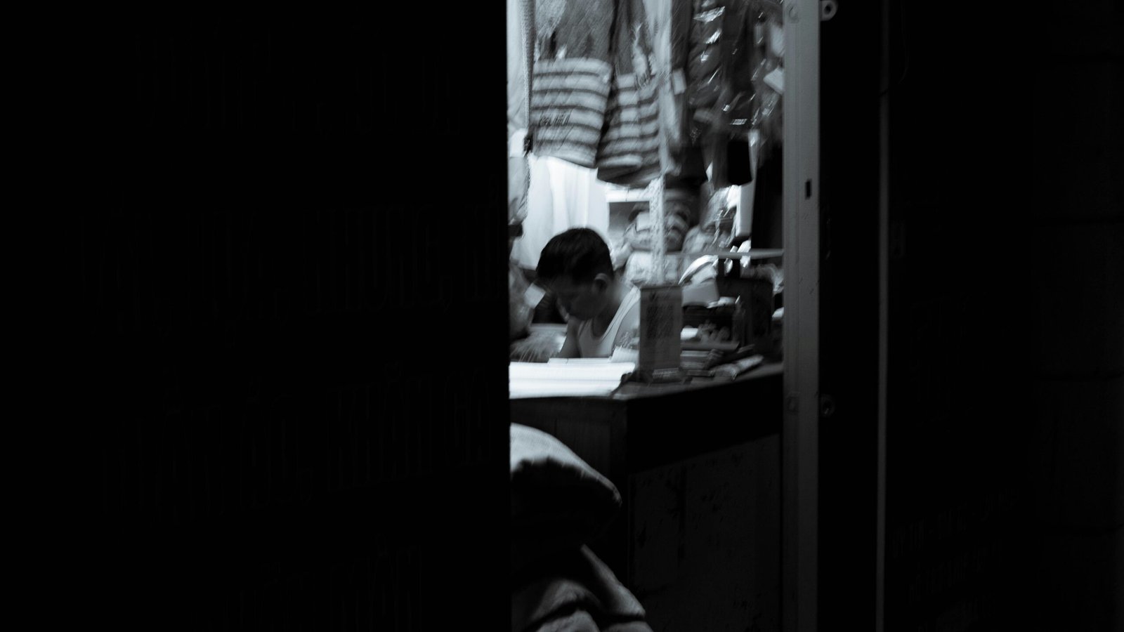 a person sitting at a desk in a dark room