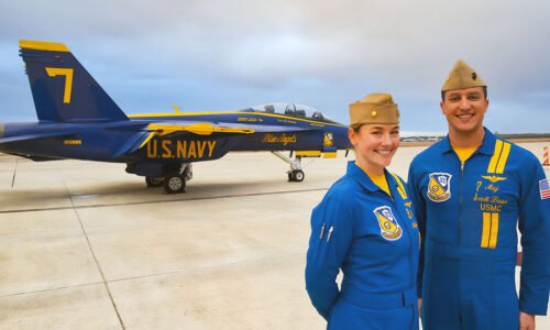 Two blue angel pilots next to a plane.
