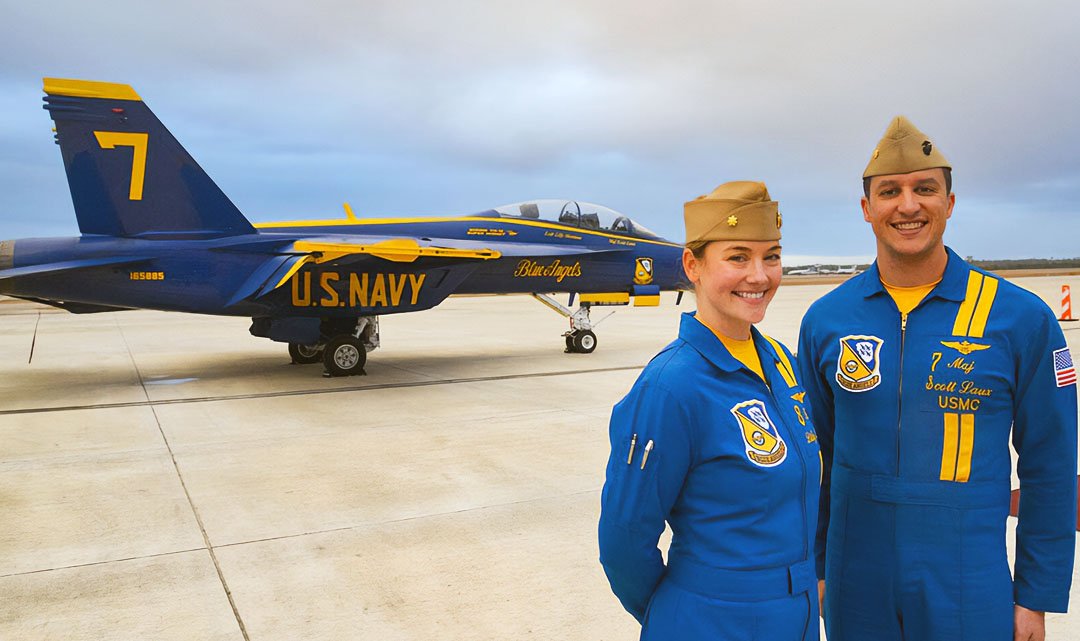 Two blue angel pilots next to a plane.