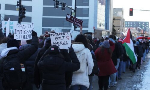 A protest on the University of Illinois Champaign-Urbana campus in January 2026. One person holds a sign that says "Immigrants Built America."