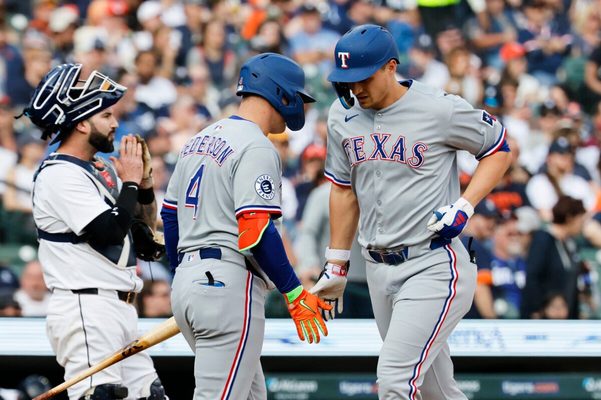 May 10, 2025; Detroit, Michigan, USA; Texas Rangers shortstop Corey Seager (5) receives congratulations from designated hitter Joc Pederson (4) after he hits a home run in the first inning against the Detroit Tigers at Comerica Park. Mandatory Credit: Rick Osentoski-Imagn Images