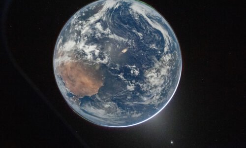 A view of Earth taken by NASA astronaut and Artemis II Commander Reid Wiseman from the Orion spacecraft's window. The image features two auroras (top right and bottom left) and zodiacal light (bottom right) is visible as the Earth eclipses the Sun.