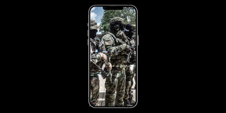 A photo of men in militia gear taken on a cell phone.