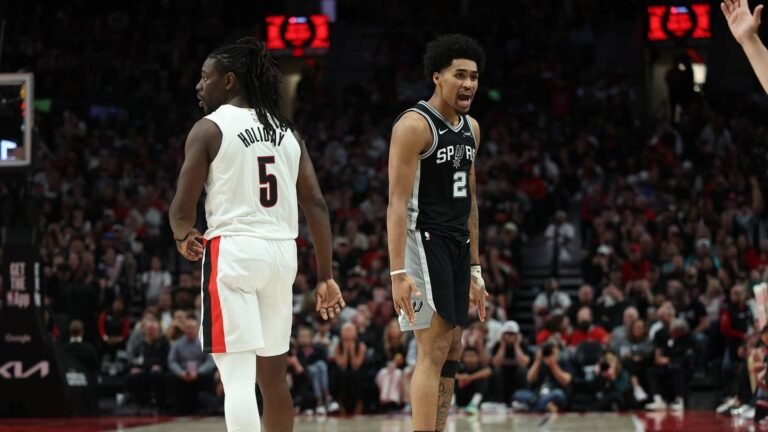 Apr 24, 2026; Portland, Oregon, USA; San Antonio Spurs guard Dylan Harper (2) reacts after scoring against Portland Trail Blazers guard Jrue Holiday (5) during the second half during game three of the first round of the 2026 NBA Playoffs at Moda Center. Mandatory Credit: Jaime Valdez-Imagn Images