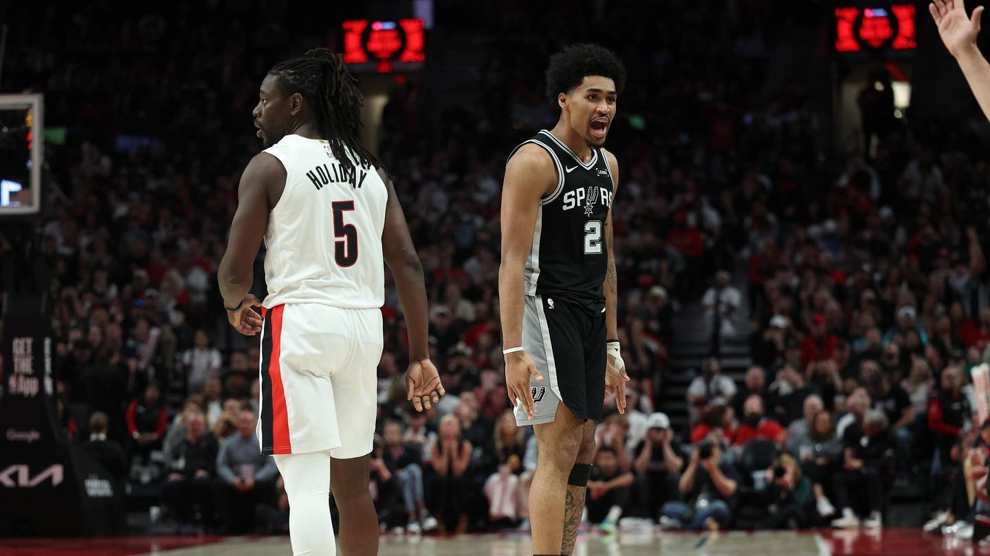 Apr 24, 2026; Portland, Oregon, USA; San Antonio Spurs guard Dylan Harper (2) reacts after scoring against Portland Trail Blazers guard Jrue Holiday (5) during the second half during game three of the first round of the 2026 NBA Playoffs at Moda Center. Mandatory Credit: Jaime Valdez-Imagn Images