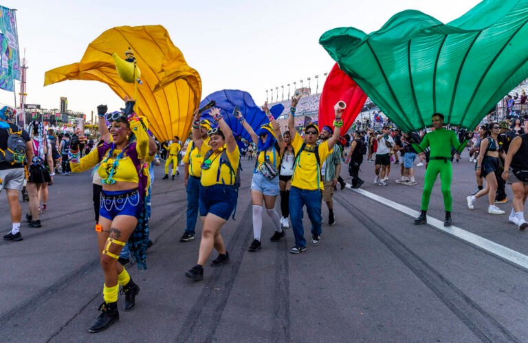 People dressed as Minions dance along the track during the first night of EDC at the Las Vegas ...
