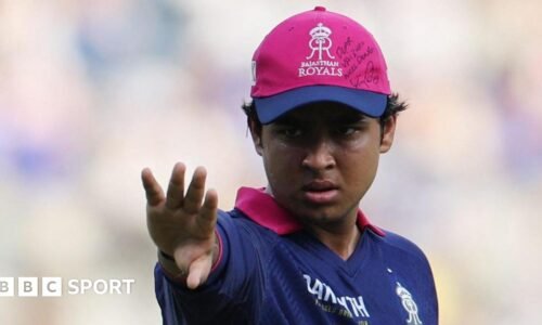 Rajasthan Royals' Vaibhav Sooryavanshi wears a cap with a message and signed by Royal Challengers Bengaluru's Virat Kohli