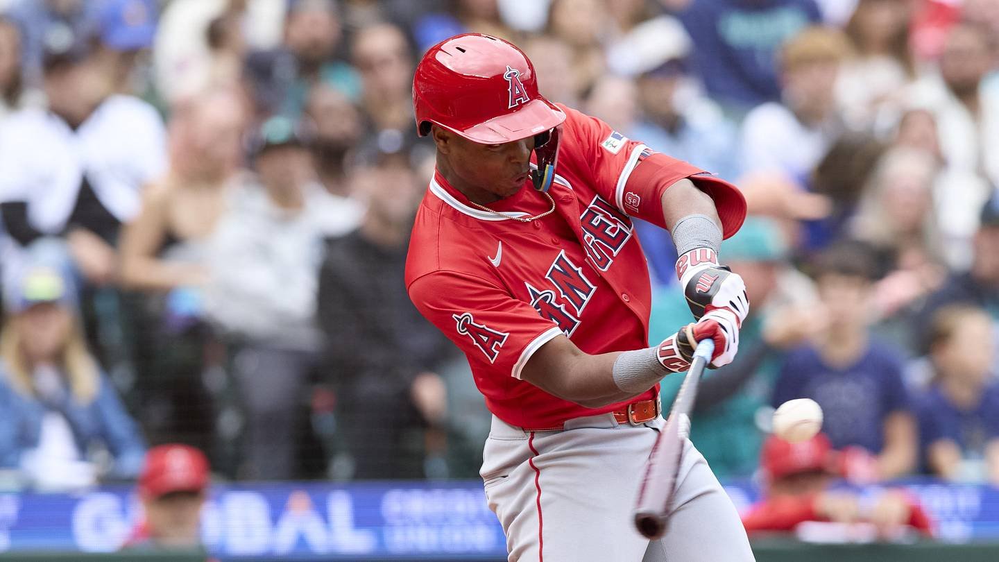 Los Angeles Angels shortstop Denzer Guzman (13) hits a single