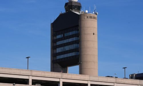 FILE - The control tower at Logan Airport, on Dec. 9, 2025, in Boston.