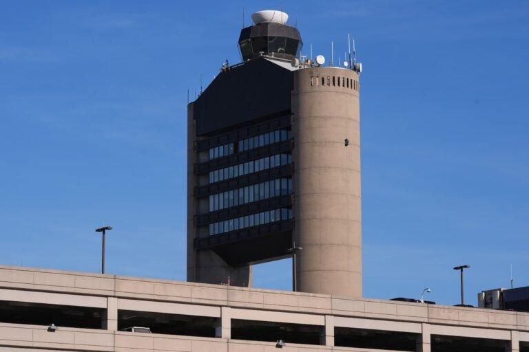 FILE - The control tower at Logan Airport, on Dec. 9, 2025, in Boston.