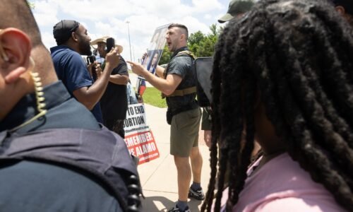 Jake Lang is removed by police for violating decorum rules while speaking in opposition to the proposed construction of a mosque and two temples during a city council meeting in Frisco, Tuesday, May 19, 2026.