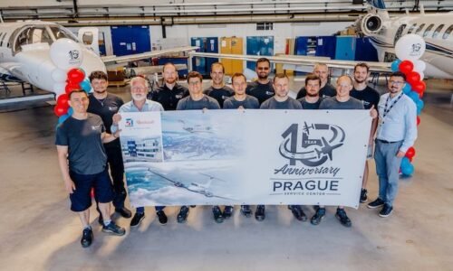 Staff hold banner celebrating Prague Service Centre's 15th anniversary