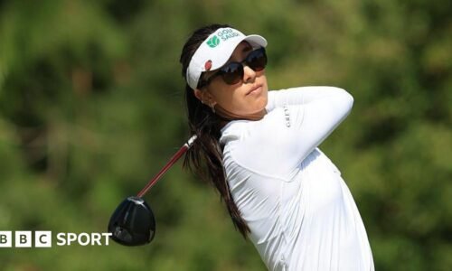Alison Lee of the United States plays her shot from the 13th tee