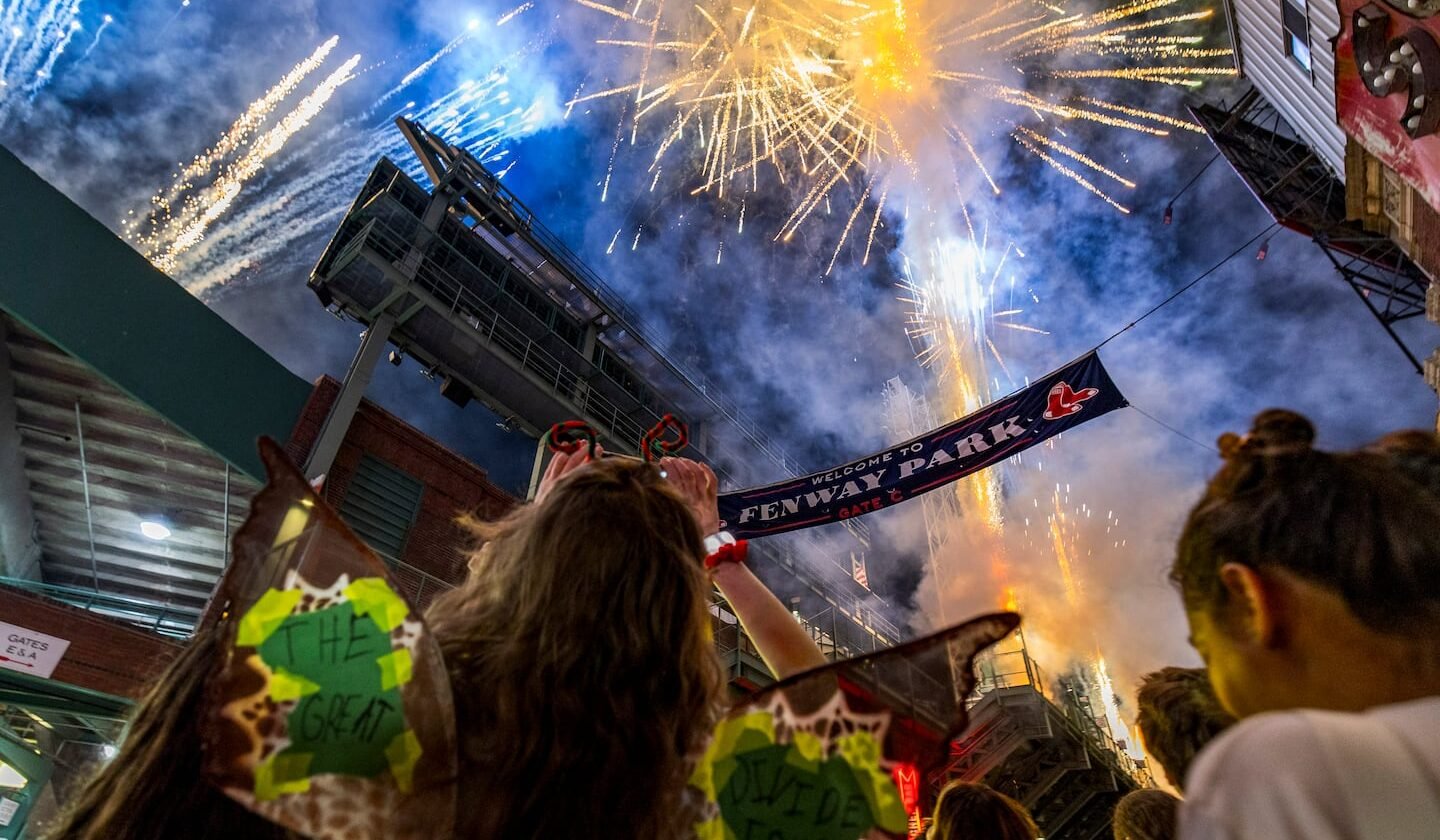 Camille Waddington takes a photo of fireworks from outside during a Noah Kahan concert inside Fenway Park in Boston, MA on July 11, 2026.
